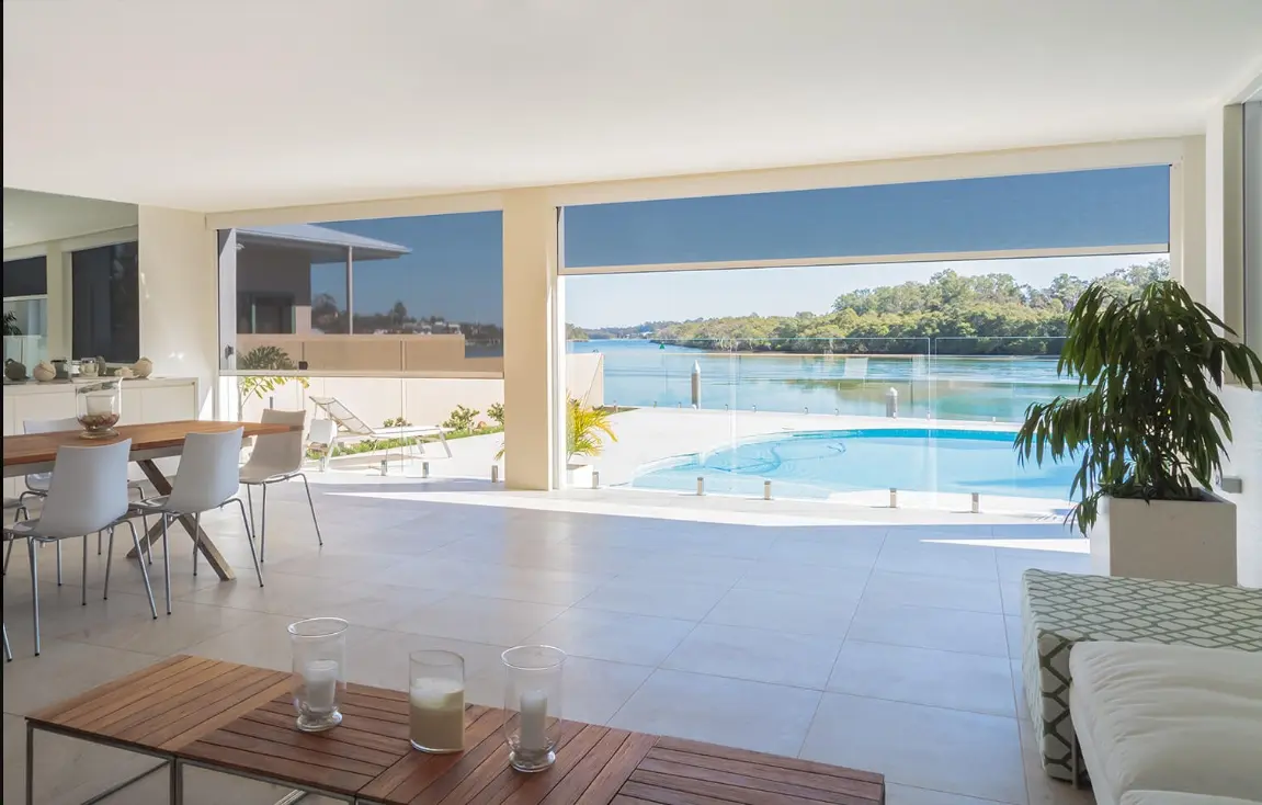 Outdoor shade enclosing a covered patio seating area