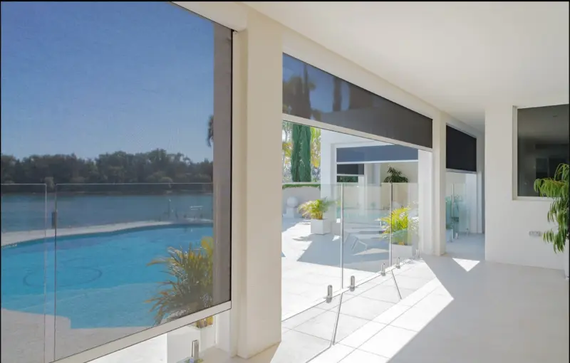 Zipscreen retractable screen lowered across a covered patio opening